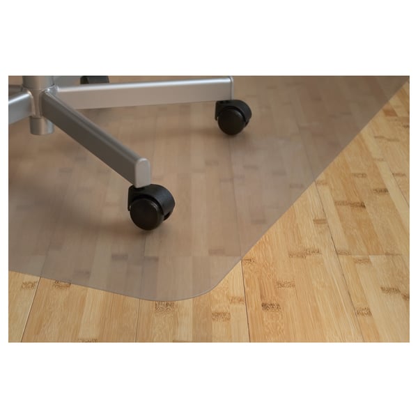 Transparent chair mat on wood floor, protecting floor from chair casters.