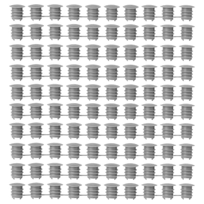 Grid of gray KOMPLEMENT polyethylene plastic cover caps, uniformly arranged, cylindrical shape with ridged design.