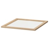 An ikea KOMPLEMENT glass shelf in clear. Its square-shaped with a light beige wood frame and made of fibreboard and tempered glass.