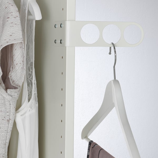A valet hanger on a closet wall, holding an empty coat hanger, designed for airing or preparing clothes.