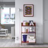 KRÖNIKÖR red shelf holds books & vases, bright in living room.