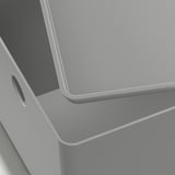 Close-up of sleek, modern gray KUGGIS box with smooth edges and a small handle on the side.