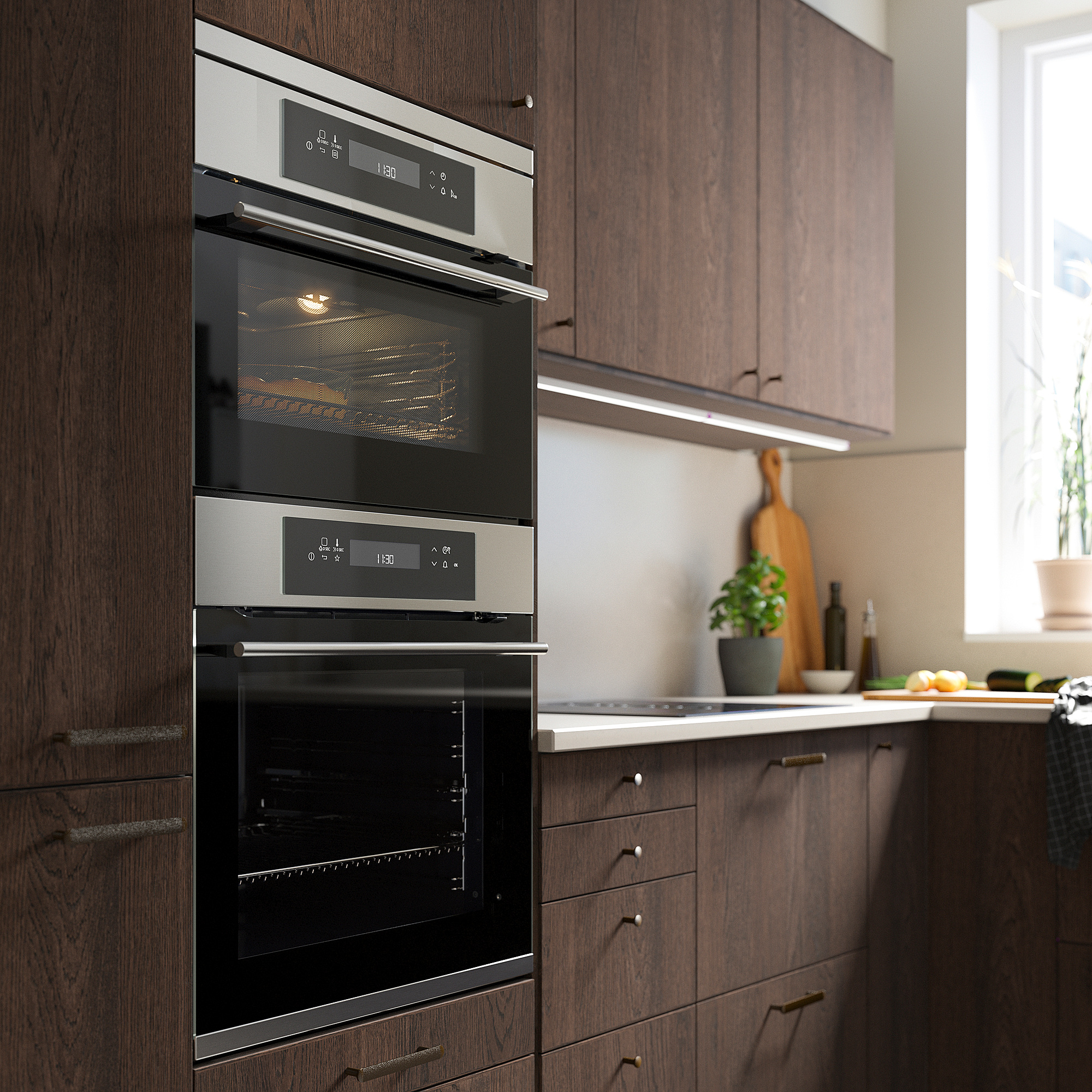 Modern kitchen with stainless steel microwave/oven combo, dark wood cabinets, and clean countertop near window.