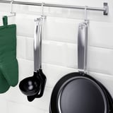Wall-mounted kitchen storage with a hanging ladle and frying pan, part of the KUNGSFORS series.