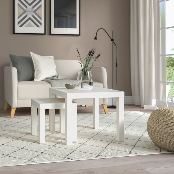 Modern living room with white LACK tables, sofa, and decor.