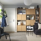 Modern living room with LÅDMAKARE storage, sofa, and coat stand.