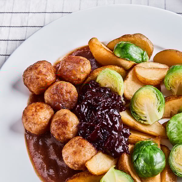 Frozen meal with roasted potatoes, chicken meatballs, brussels sprouts, and gravy.