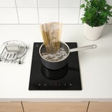 Spaghetti boiling on induction hob.