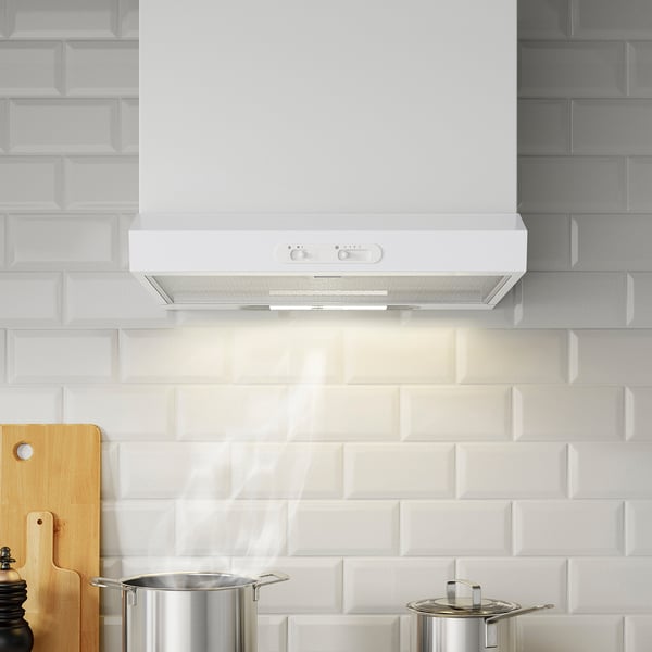 Modern kitchen hood with led lights above white-tiled backsplash, control panel, ducted or recirculating.