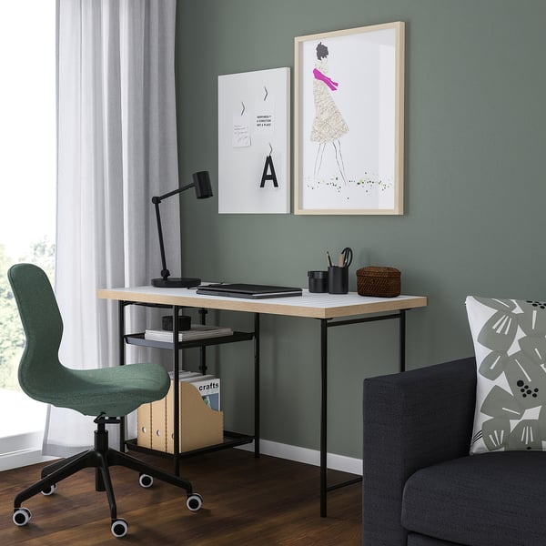 Minimalist home office with LAGKAPTEN desk, green chair, lamp, art, and natural light