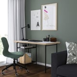 Minimalist home office with LAGKAPTEN desk, green chair, lamp, art, and natural light