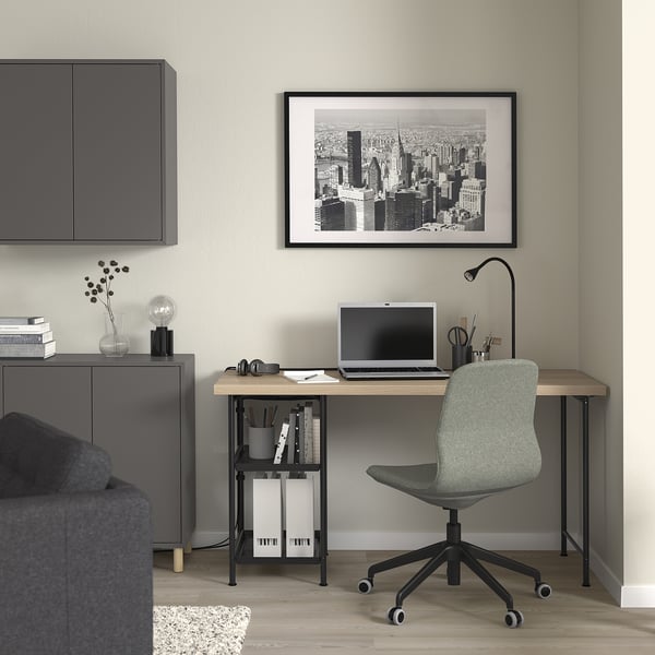 Home office with LAGKAPTEN desk, chair, lamp, and cityscape photo.