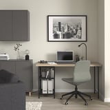 Home office with LAGKAPTEN desk, chair, lamp, and cityscape photo.