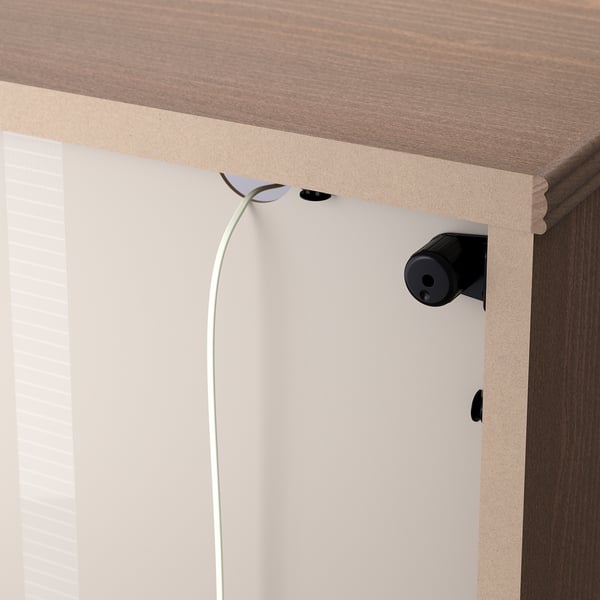 Close-up of a LANESUND bookshelf cable management clip.