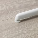 White childrens chair with adjustable feet for stability on uneven floors.