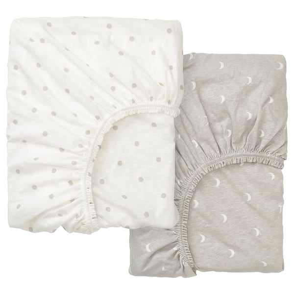 Two light-colored fitted sheets with dot patterns, one white and one gray, folded neatly.