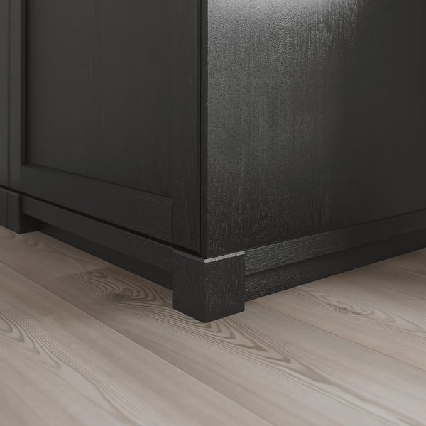 Black wooden kitchen plinth on light floor, showing robust design.