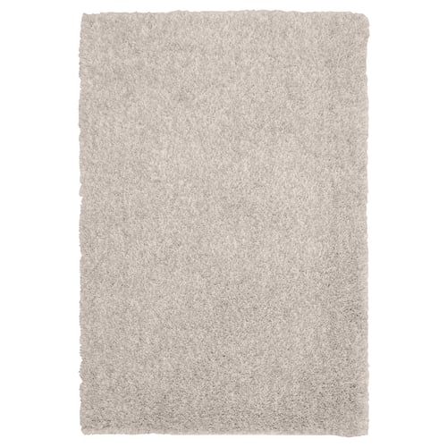 Soft beige LINDKNUD rug. Rectangular, plush texture from recycled polyester. Ideal for bedrooms.