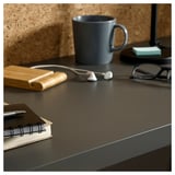 A black LINNMON table top with items on it.