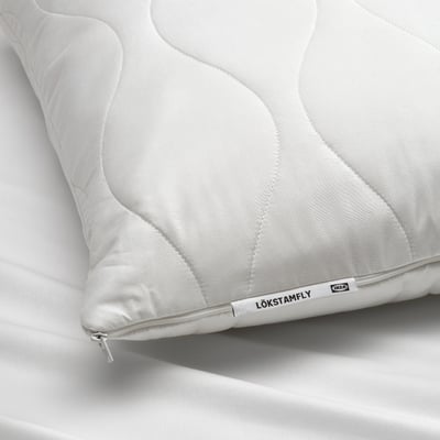 White LÖKSTAMFLY ergonomic shredded memory foam pillow, quilted cover, square shape.