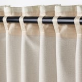 Curtain close-up, showing block-out fabric, heading tape, and rod pocket, designed to darken rooms.