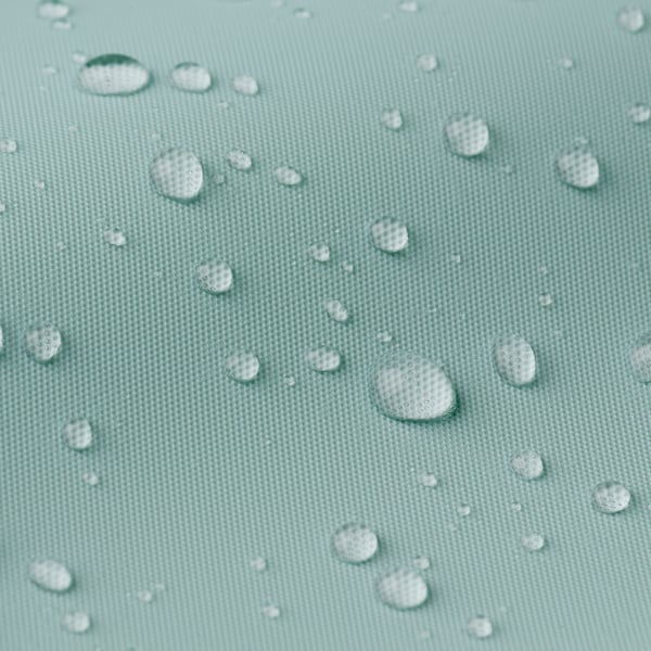 Water droplets on textured, light green shower curtain, illustrating its water-repelling feature.