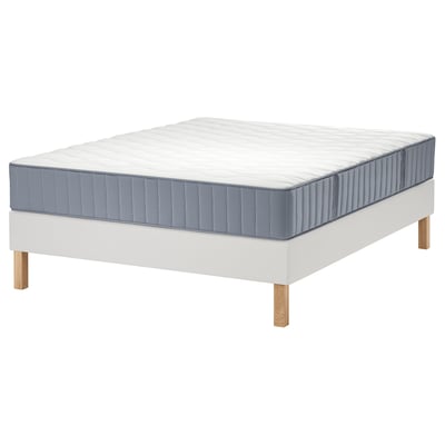 White LYNGÖR bed with blue mattress, wooden legs.