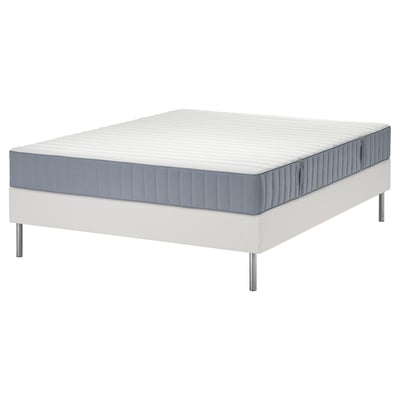 Modern white platform bed with blue-gray mattress featuring five comfort zones and pocket springs for support.