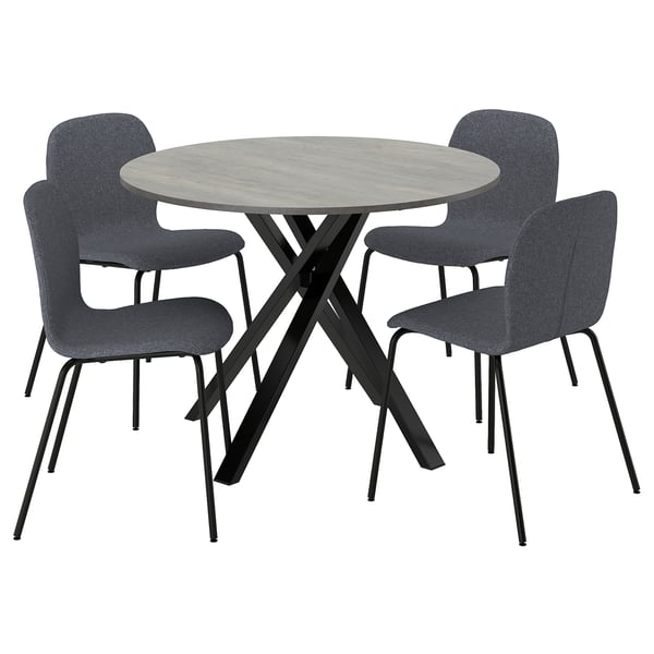 Round dining set with gray chairs and concrete-style table, sleek metal legs.