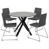 Modern round dining table with sleek metal legs and three matching grey fabric chairs.
