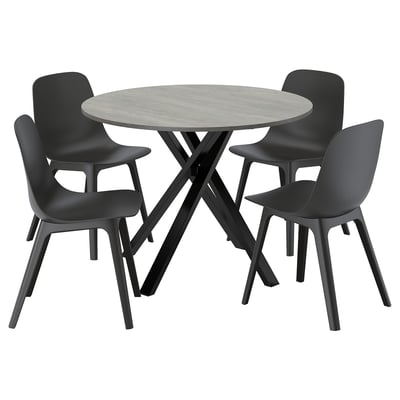 Grey round dining set with 4 black chairs, stone table, comfy design.