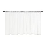 White sheer curtains with lace detail hang drawn back on a black rod, allowing light through and providing a sense of privacy.