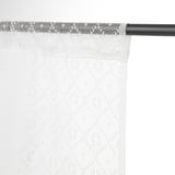 Light white curtains hang from black rod, offering privacy and filtering daylight.