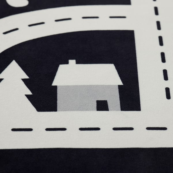Abstract black and white rug depicting houses and trees, showcasing high-quality design and material.