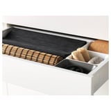 White drawer system withMAXIMERA; pulls out fully, closes softly; contains cleaning tools.