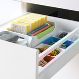 Organized drawer with sponges, cloths, and tools, featuring maximized access and quiet close.