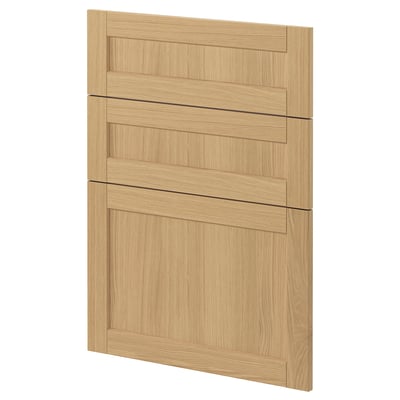 A light wooden cabinet door from ikeas METOD system, featuring oak veneer and beveled edges, designed for a classic kitchen look.