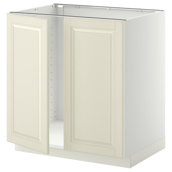 A white METOD kitchen cabinet with two off-white beveled doors. It has a sturdy frame and snap-on hinges.