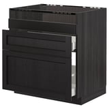 Black stained wooden kitchen cabinet with beveled edges, featuring three drawers, two open, showcasing modern design.