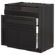 Black stained wooden kitchen cabinet with beveled edges, featuring three drawers, two open, showcasing modern design.