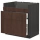 A modern kitchen cabinet from ikeas METOD series in dark brown with oak veneer and solid wood edging, featuring multiple drawers.