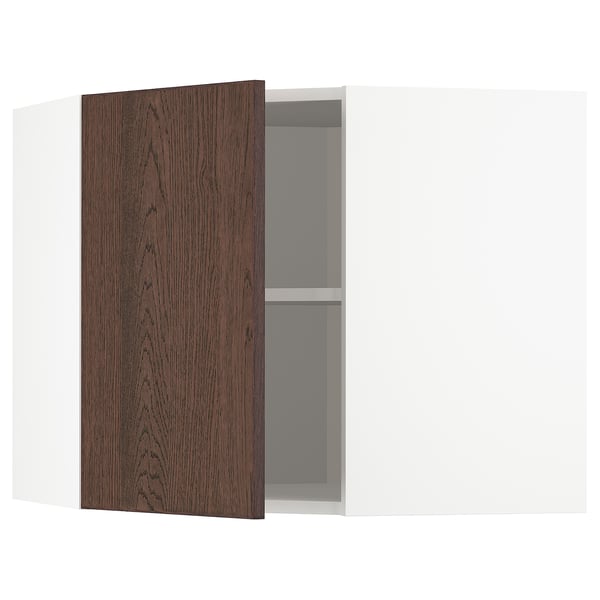 An open white corner cabinet with a dark brown wooden door and a single shelf inside.