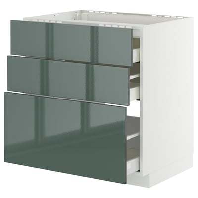 Modern kitchen cabinet with three green-gloss drawers, sleek design, sturdy frame, smooth drawer runners.