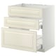 A white and beige kitchen cabinet system with drawers. It a modern, minimalist design with smoothly integrated hardware.