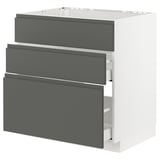 Displays a white METOD kitchen cabinet with three dark grey drawers featuring integrated handles. The cabinet has a sleek, modern design.