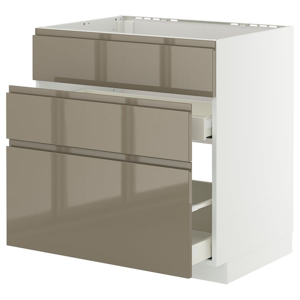 Modern kitchen unit with three dark grey-brown metallic drawers, sleek handles, and a white frame.