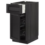 Displays a black stained ash METOD kitchen cabinet with a wooden drawer and wire basket pulled out. It a smooth and traditional design.