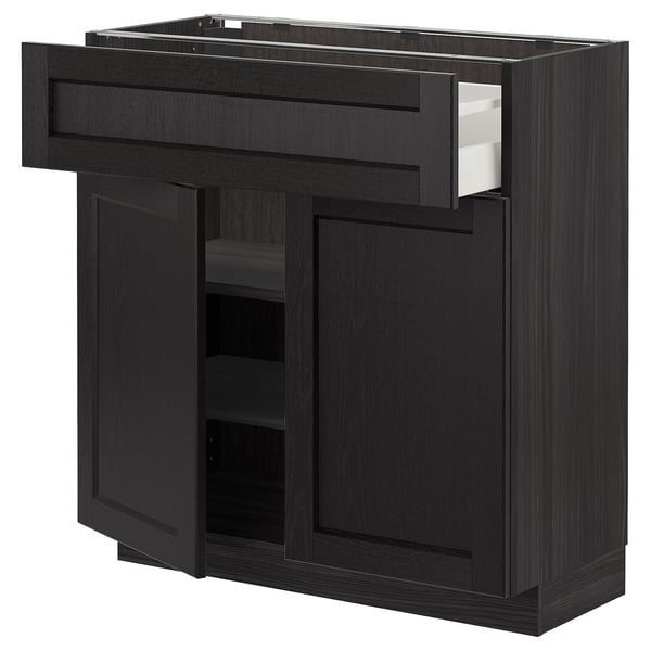 Black METOD kitchen unit with open drawer and cabinet. Dark stained wood, rectangular shape, bevelled edges.