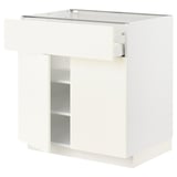 A white METOD kitchen cabinet with a smooth drawer. It a sleek, modern design with a single adjustable shelf inside.