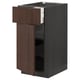 Brown wooden kitchen cabinet with open drawer, dark handles, vertical panels.